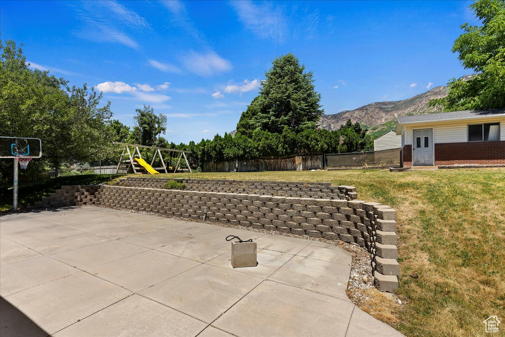 View of patio / terrace featuring a mountain view and a playground