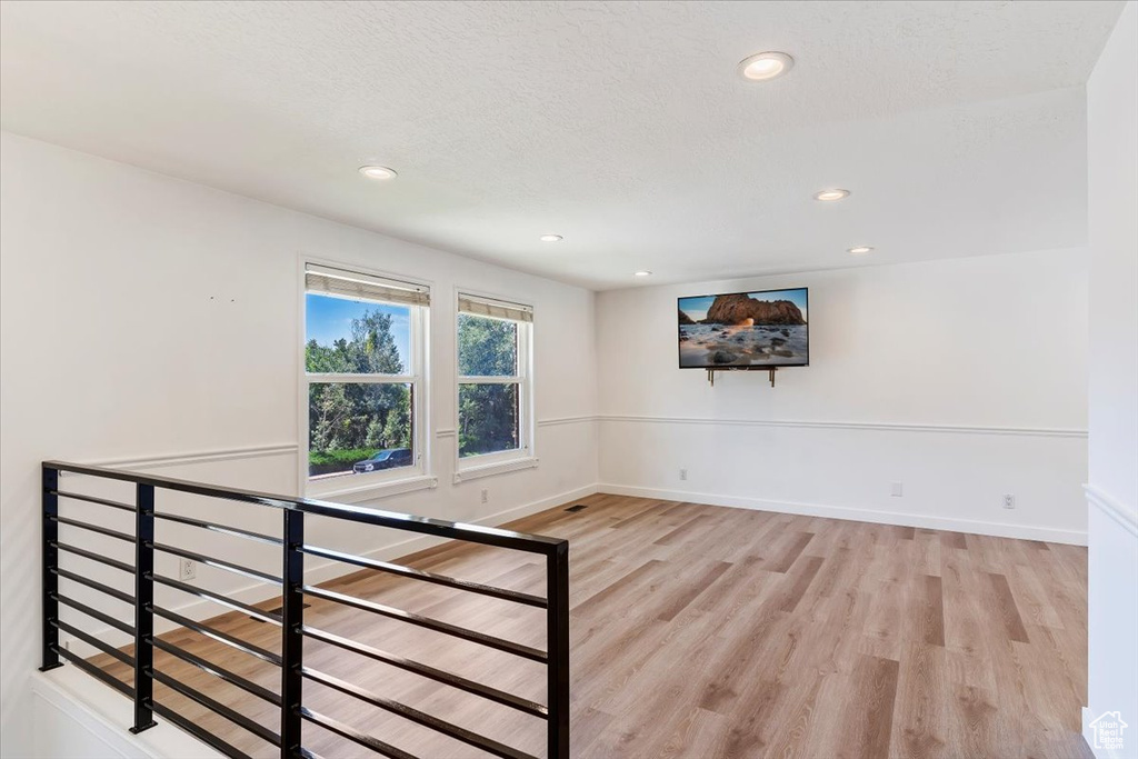 Stairs with light hardwood / wood-style flooring