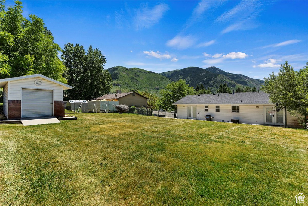 View of yard with an outbuilding and a mountain view