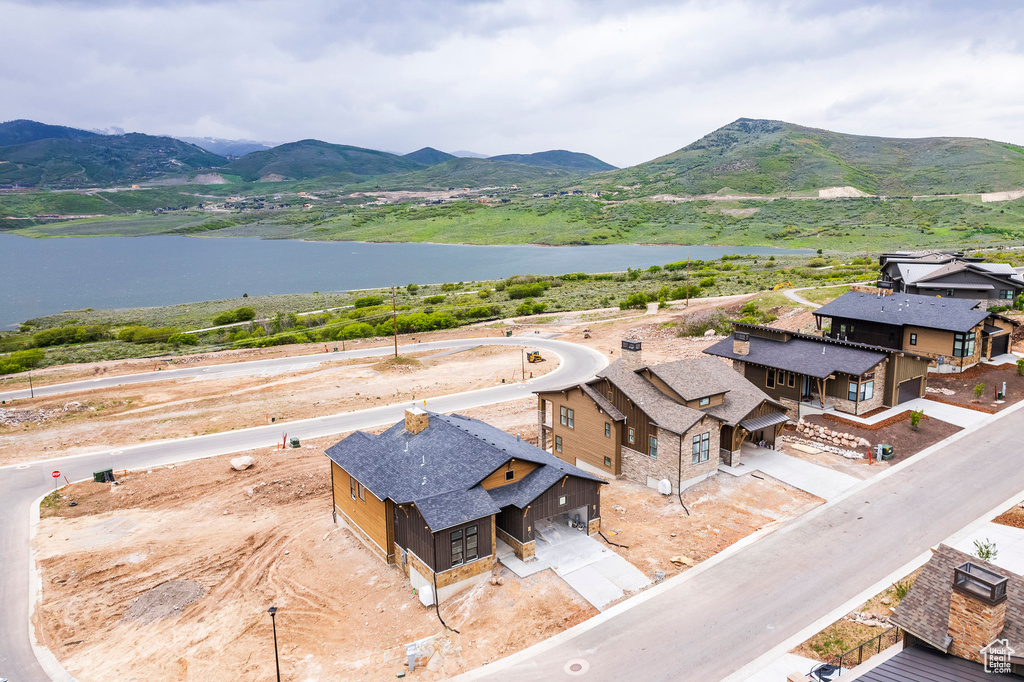 Drone / aerial view featuring a water and mountain view