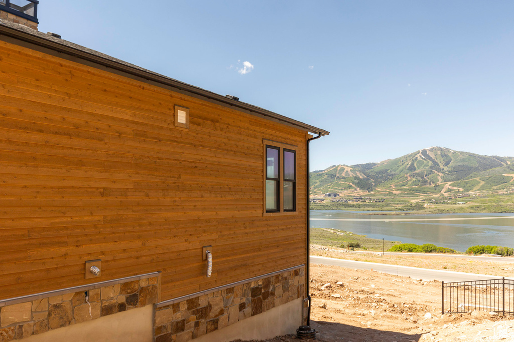 View of home's exterior with a water and mountain view