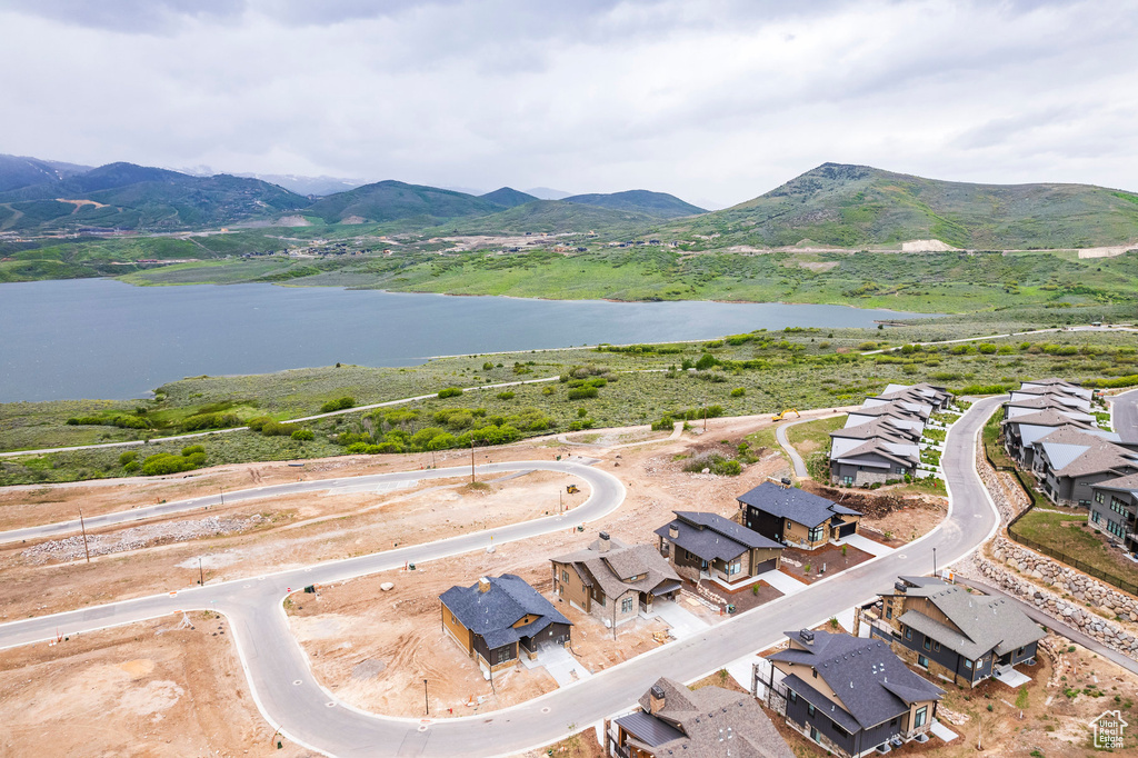 Birds eye view of property featuring a water and mountain view