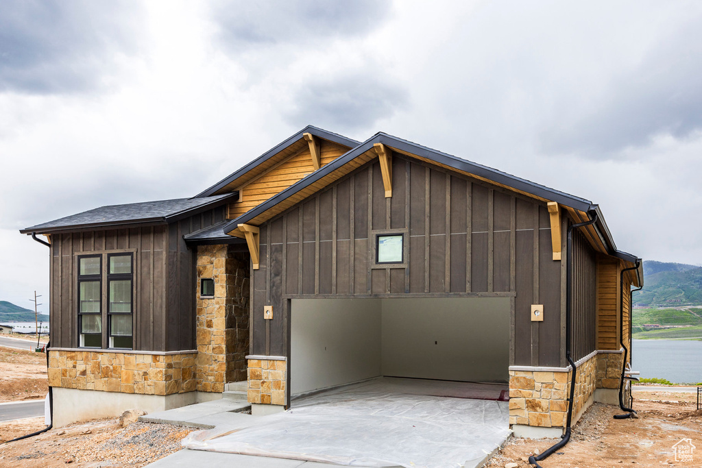 View of front facade featuring a garage and a water view