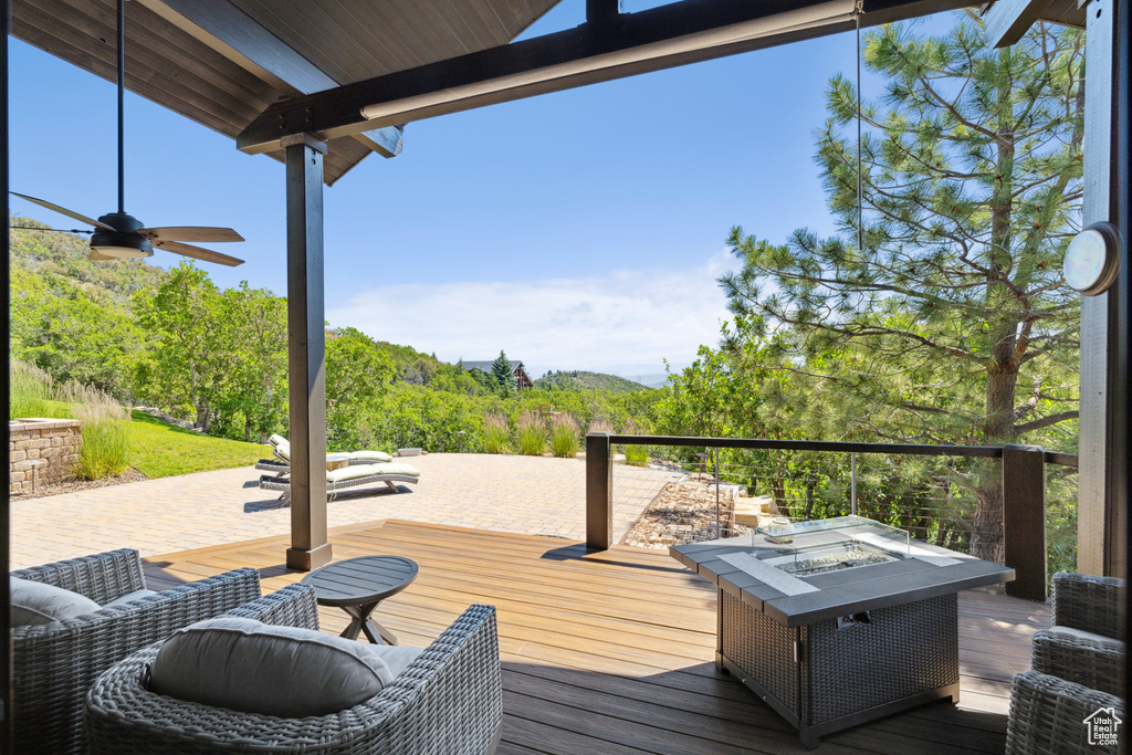 Deck with an outdoor living space with a fire pit