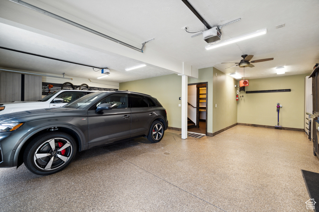 Garage featuring ceiling fan and a garage door opener