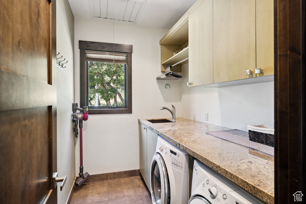 Laundry area with separate washer and dryer, cabinets, and sink