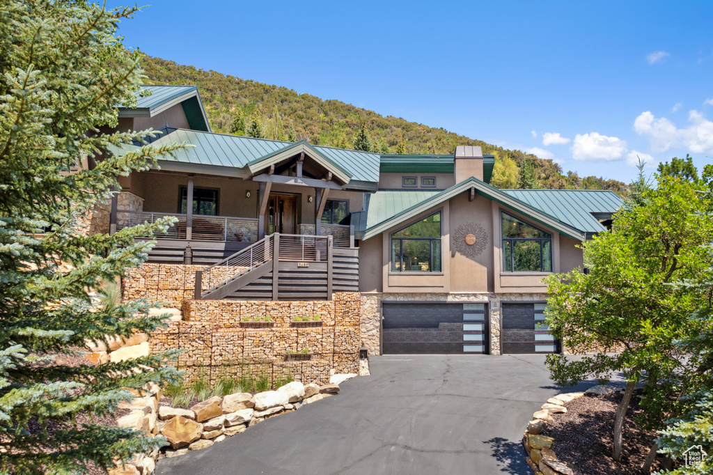 View of front of property featuring a garage and covered porch