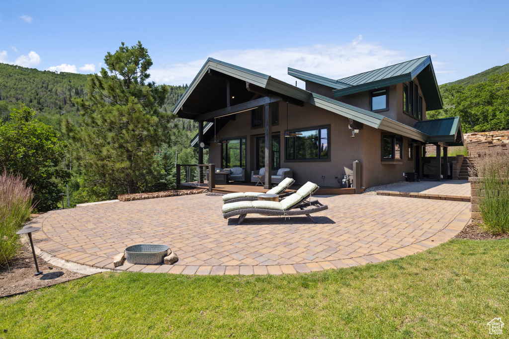 Back of property featuring a patio area and a yard