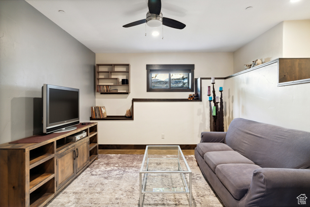 Living room featuring ceiling fan and hardwood / wood-style floors