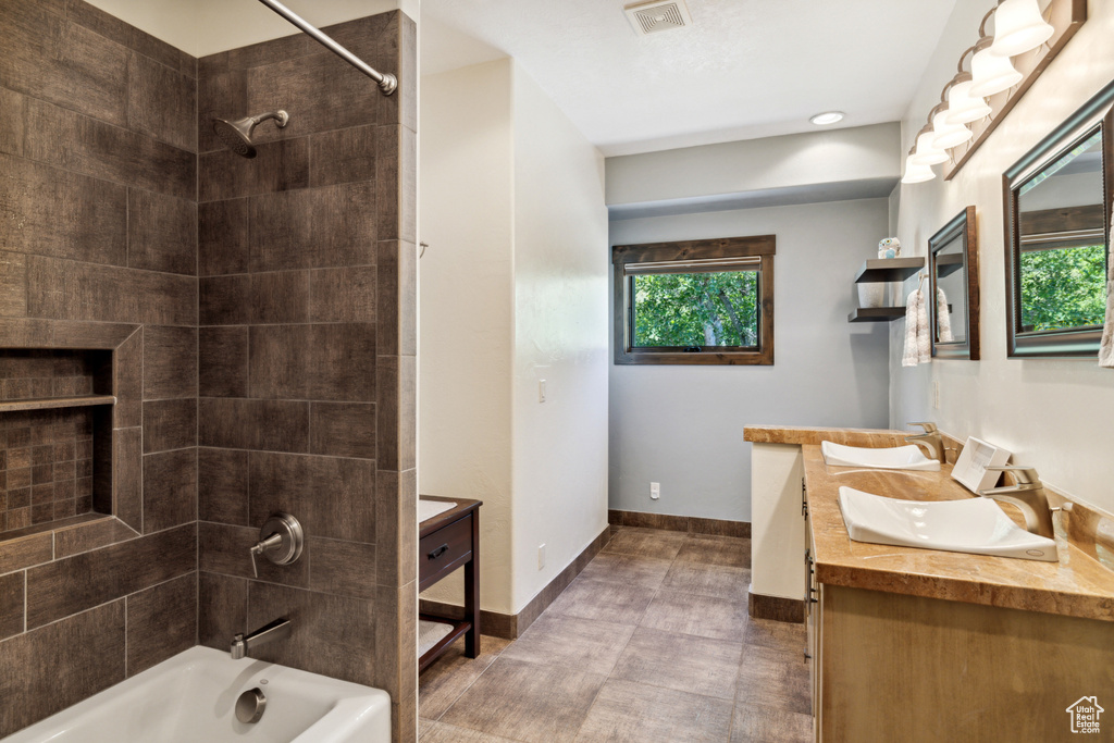 Bathroom with vanity and tiled shower / bath