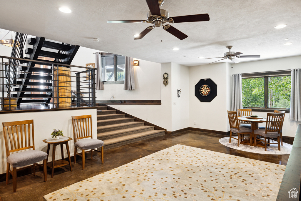 Interior space featuring a textured ceiling and ceiling fan