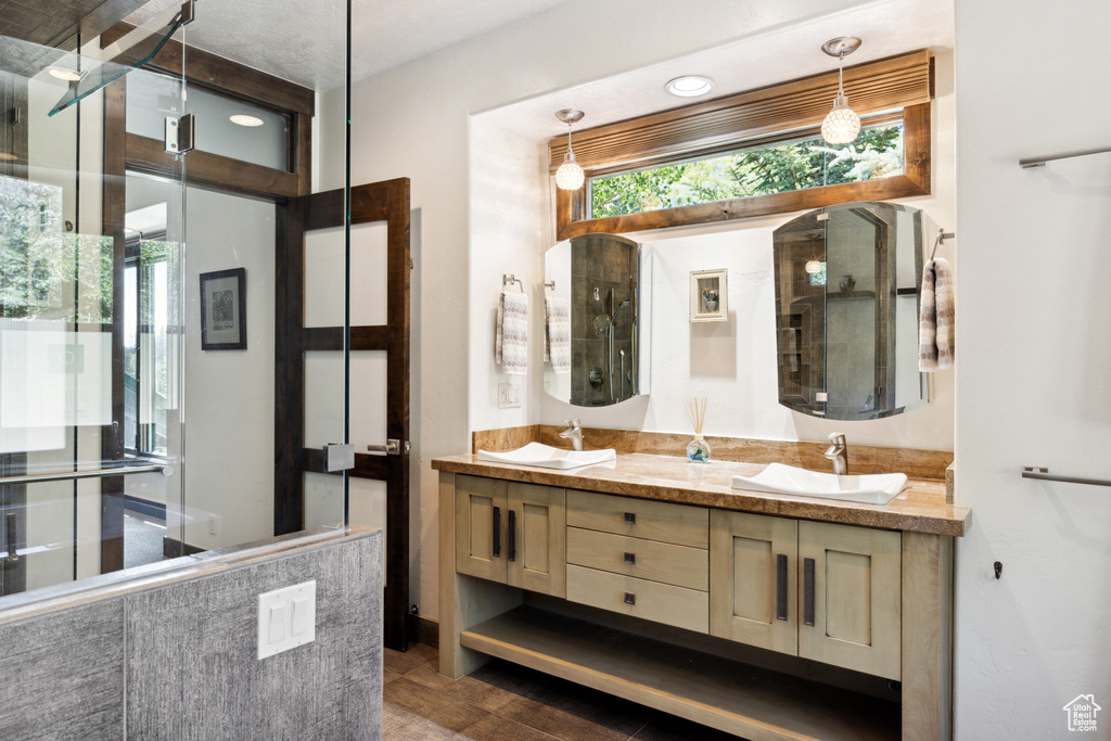 Bathroom featuring vanity, an enclosed shower, and hardwood / wood-style flooring