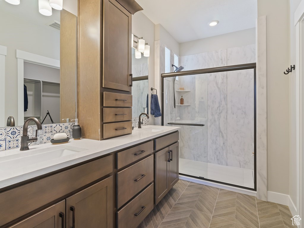 Bathroom with double sink vanity and an enclosed shower