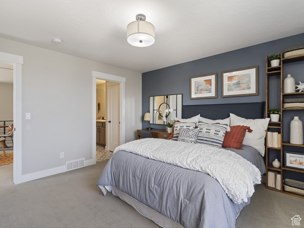 Bedroom with carpet floors and connected bathroom