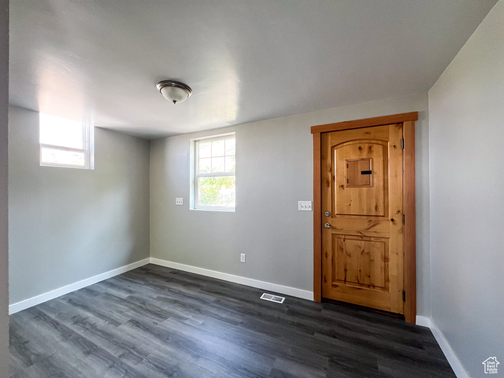 Unfurnished room featuring dark hardwood / wood-style floors