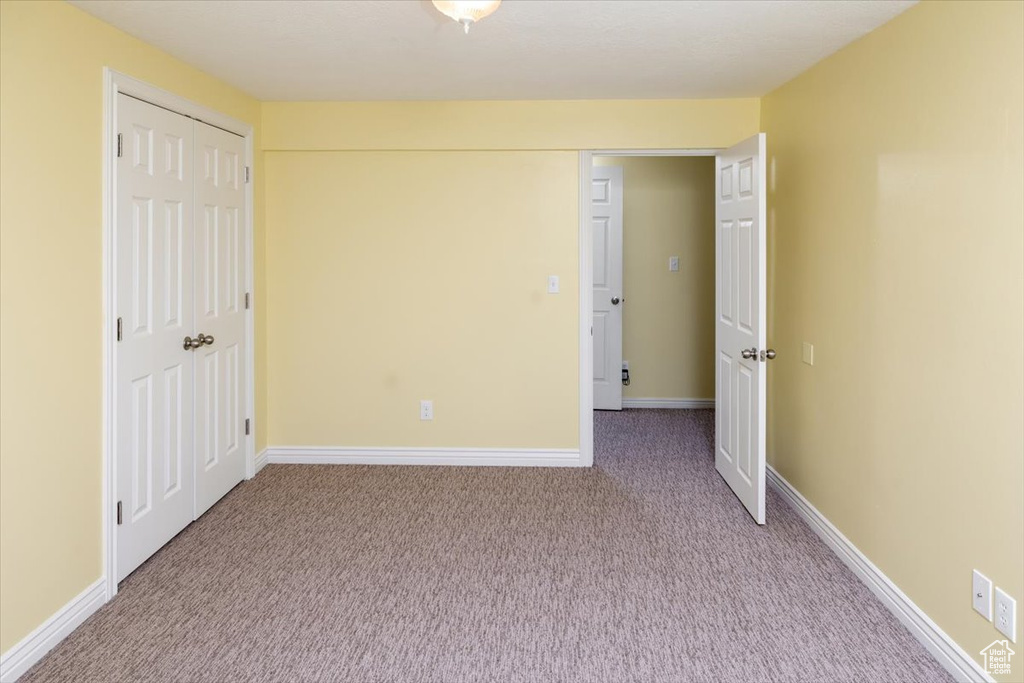 Unfurnished bedroom featuring a closet and carpet flooring