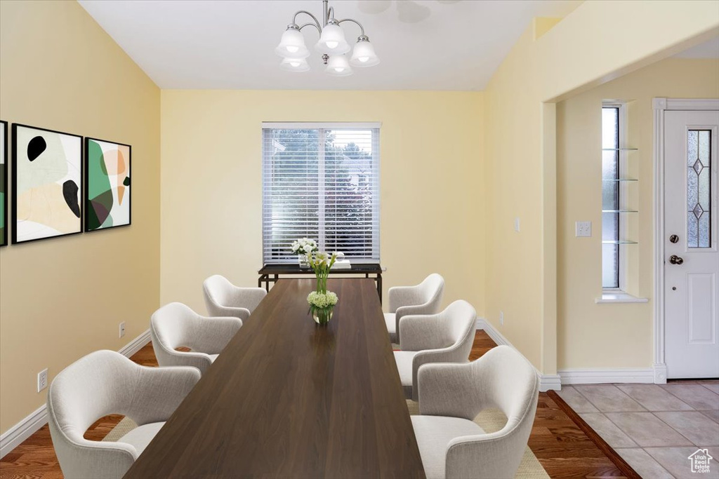 Dining room featuring light hardwood / wood-style floors, an inviting chandelier, and a wealth of natural light