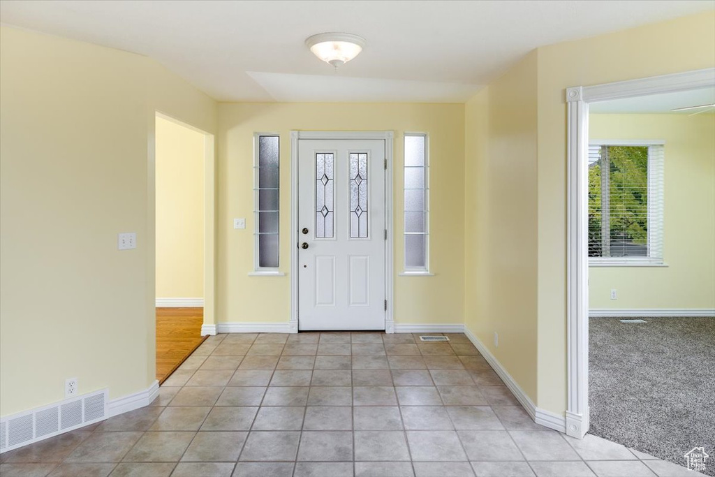 Foyer featuring light carpet