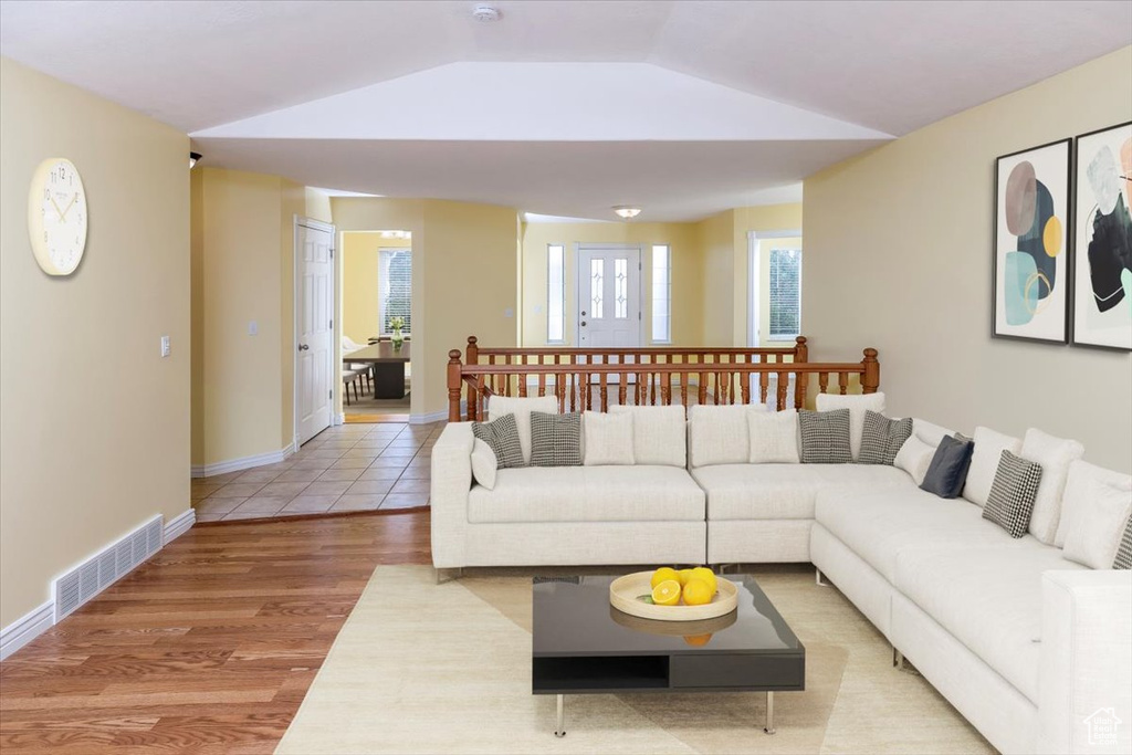 Living room featuring hardwood / wood-style flooring and lofted ceiling