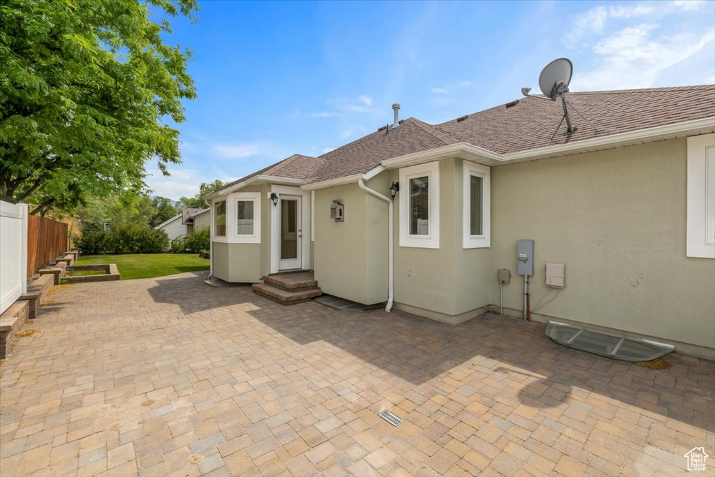 Back of property with a patio