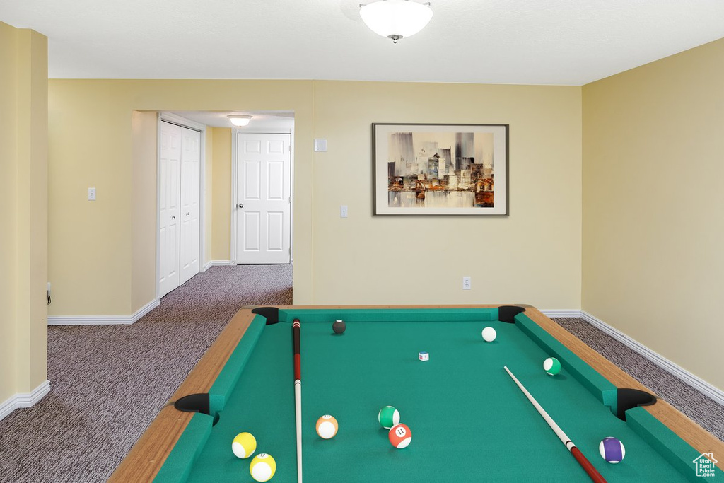 Recreation room with pool table and dark colored carpet