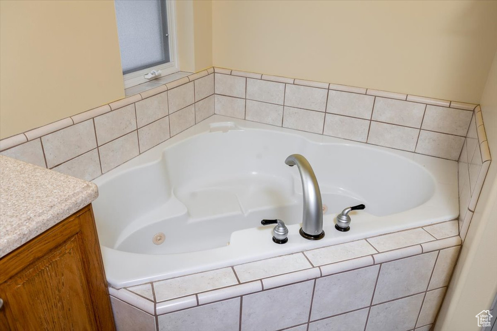 Bathroom with a relaxing tiled tub and vanity