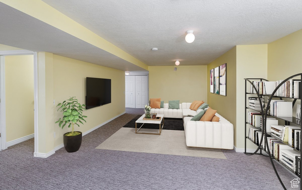 Carpeted living room featuring a textured ceiling