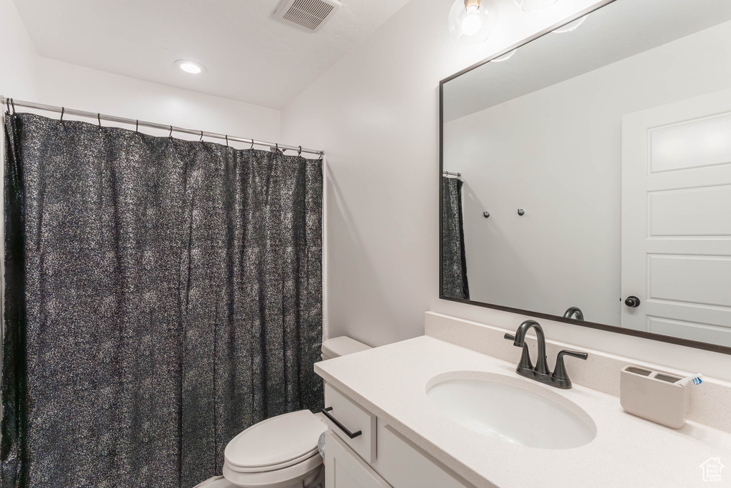 Bathroom featuring vanity and toilet