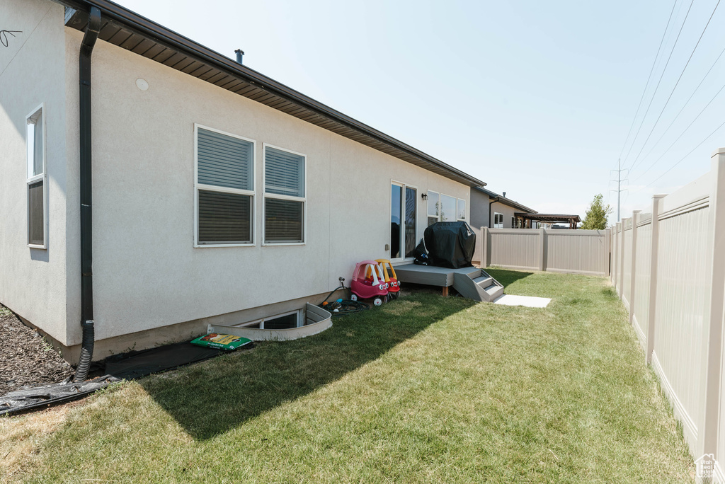 Rear view of house with a yard