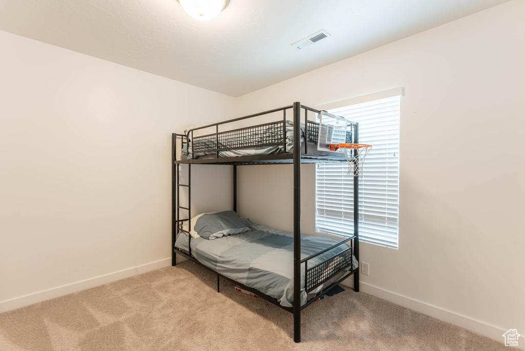 Unfurnished bedroom with carpet flooring
