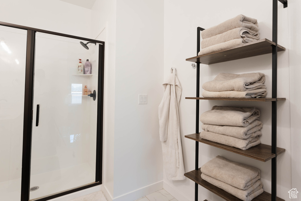 Bathroom featuring tile patterned flooring and an enclosed shower