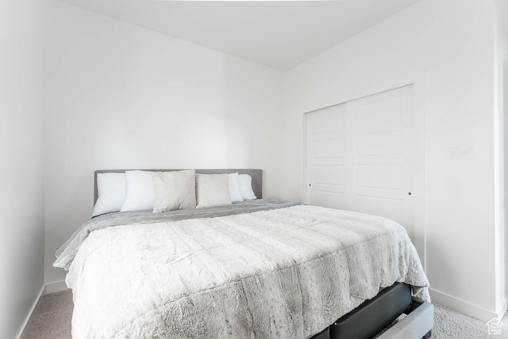 Bedroom featuring a closet and carpet floors
