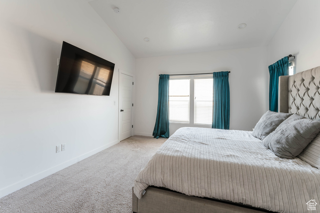 Bedroom with carpet and lofted ceiling