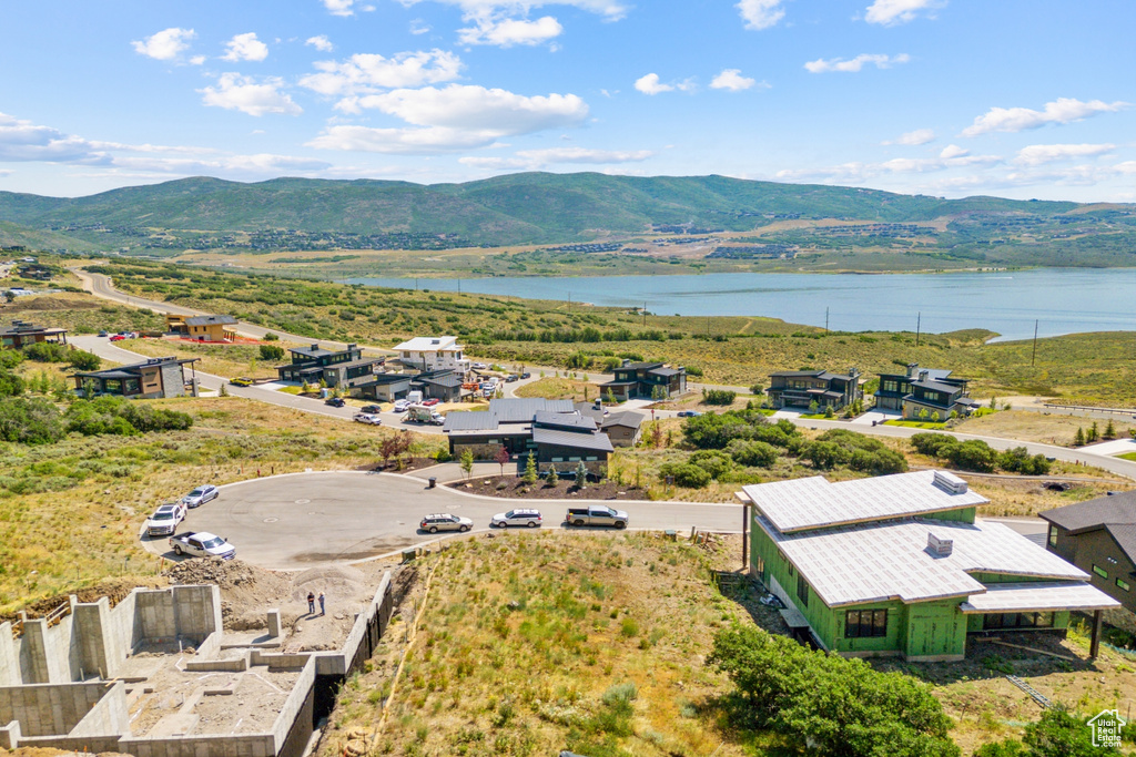 Birds eye view of property featuring a water and mountain view