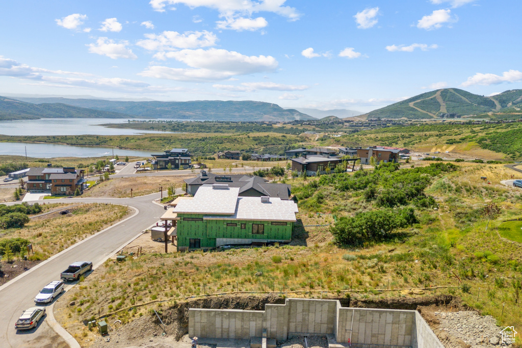 Drone / aerial view featuring a water and mountain view