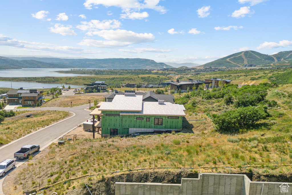 Birds eye view of property with a water and mountain view