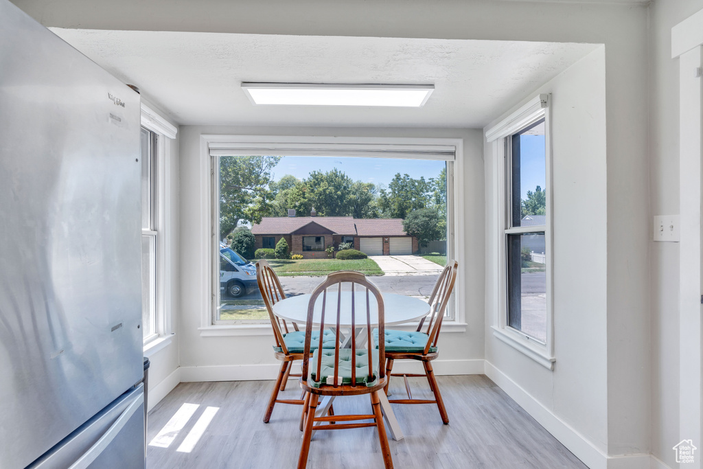 Dining room featuring light hardwood / wood-style flooring and a healthy amount of sunlight