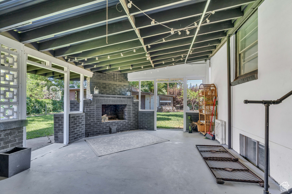 View of patio / terrace featuring an outdoor brick fireplace