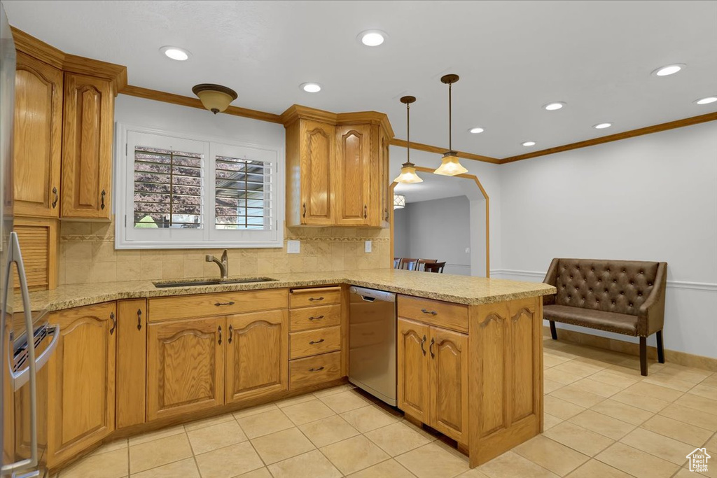 Kitchen with light tile patterned flooring, hanging light fixtures, decorative backsplash, sink, and dishwasher