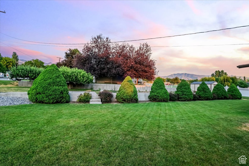 Yard at dusk with a mountain view