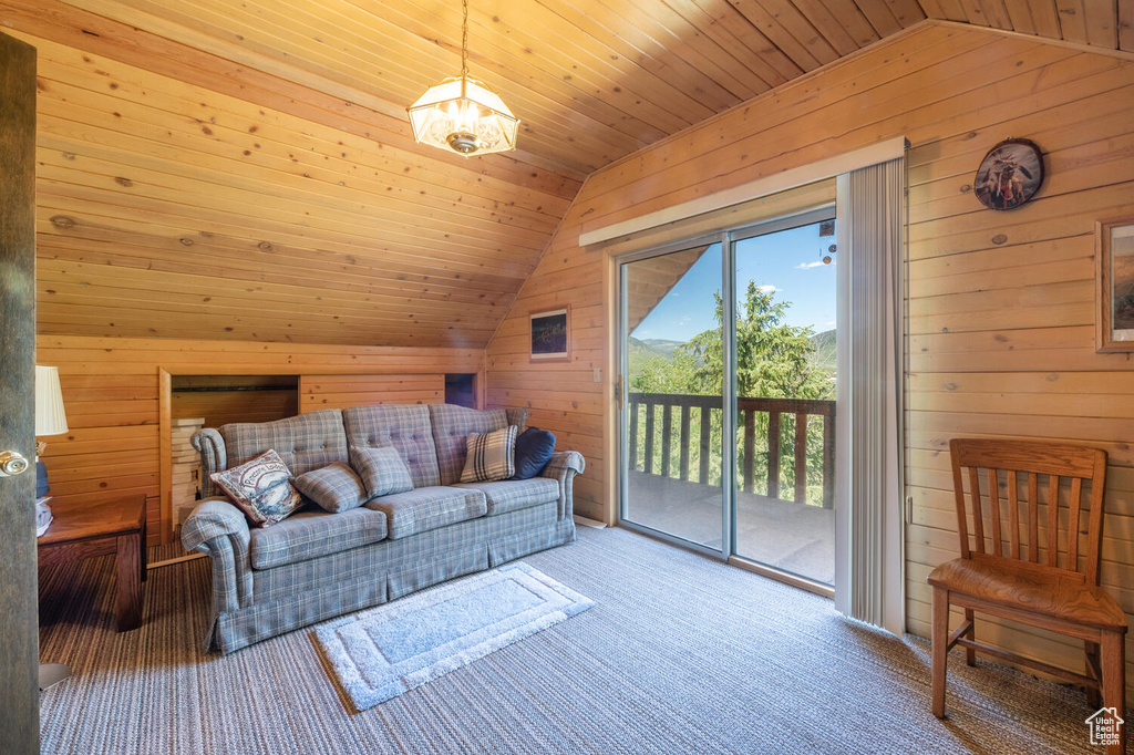 Living room featuring wood walls, light carpet, wooden ceiling, and lofted ceiling