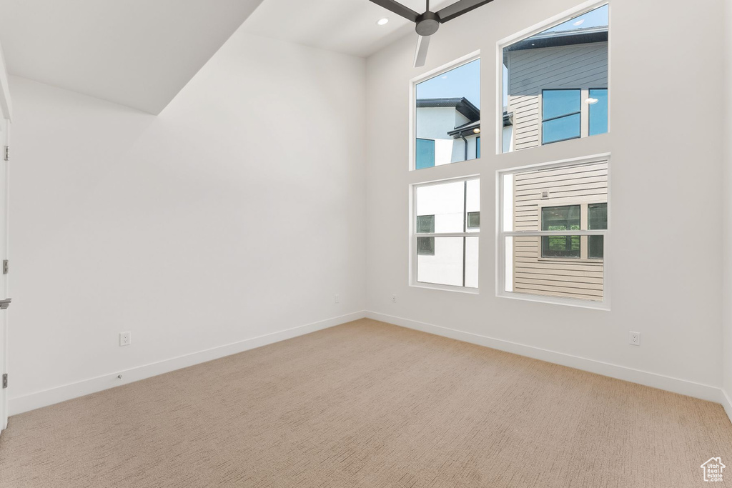 Unfurnished room with carpet floors and ceiling fan