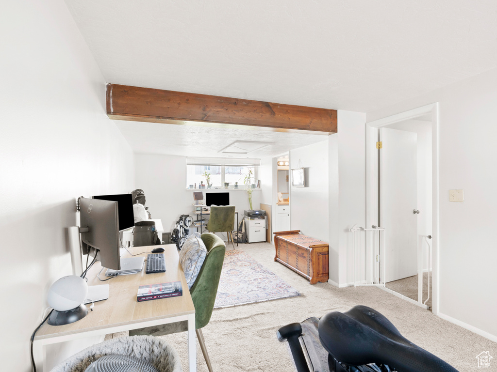 Carpeted office with beamed ceiling