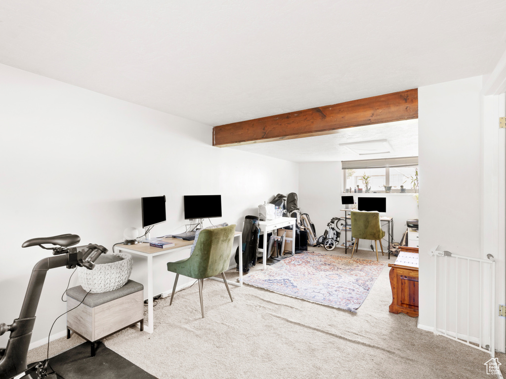 Carpeted office with beam ceiling