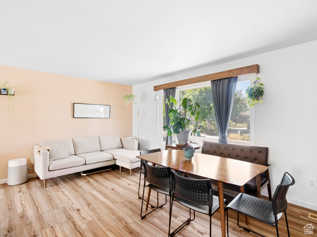 Dining area with light hardwood / wood-style flooring