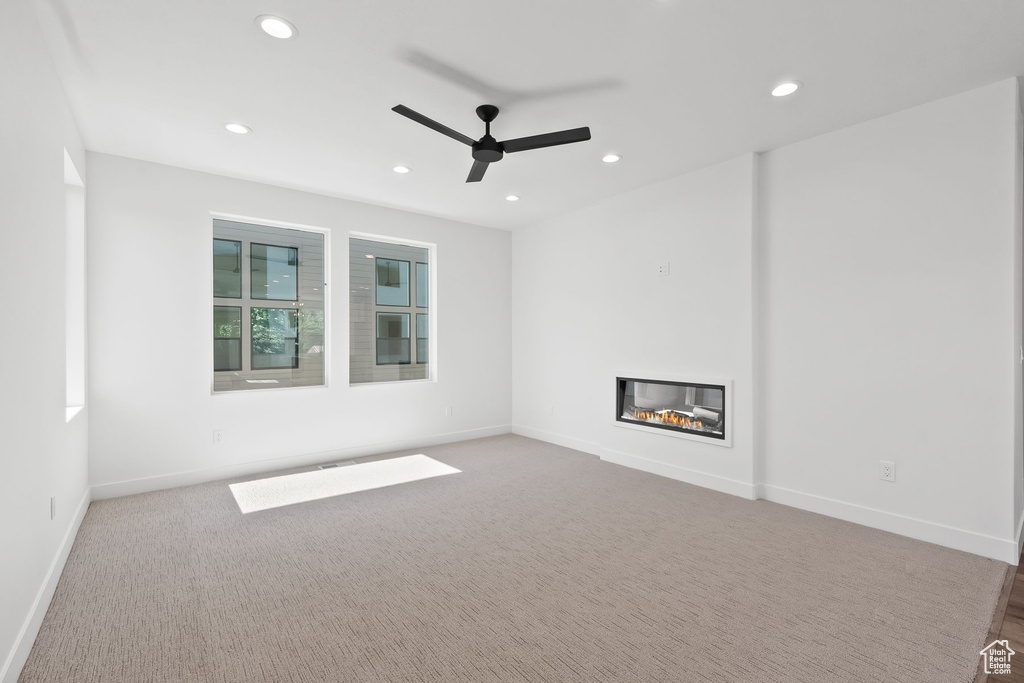 Spare room featuring ceiling fan and carpet flooring