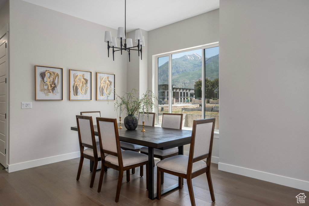 Dining room with a chandelier, dark hardwood / wood-style floors, and a mountain view