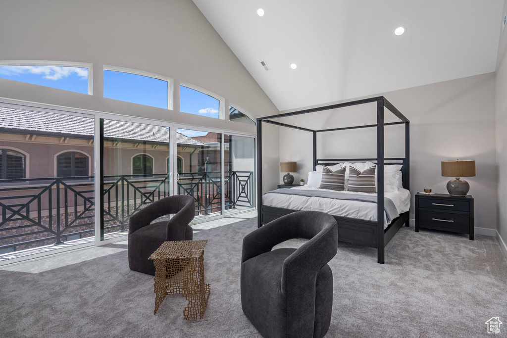 Bedroom with carpet floors, access to outside, and high vaulted ceiling