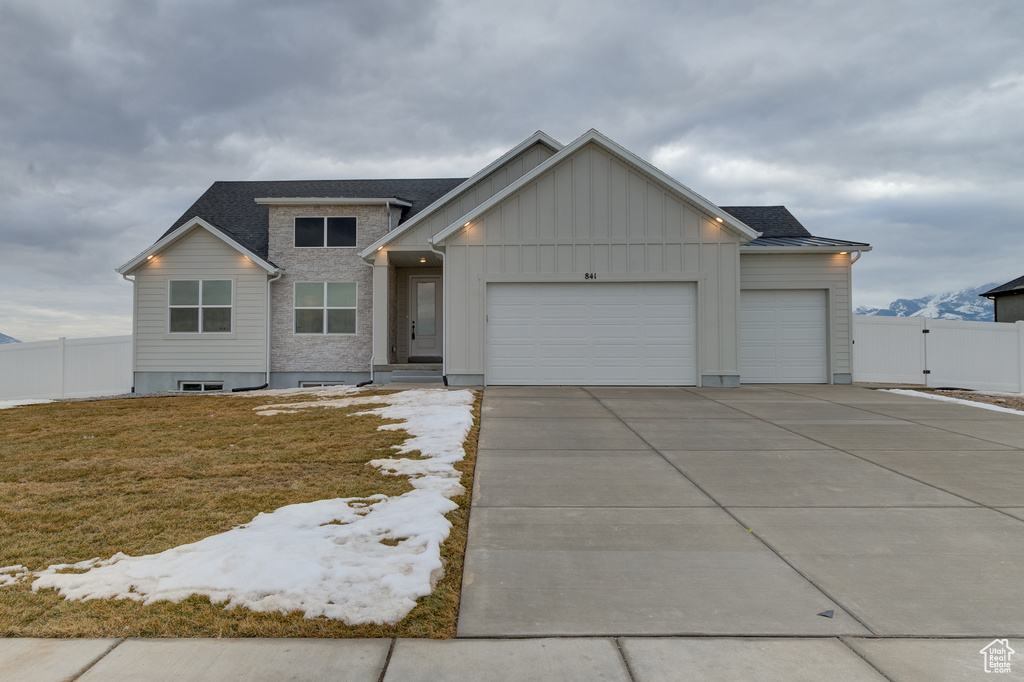 View of front of home with a garage and a front yard