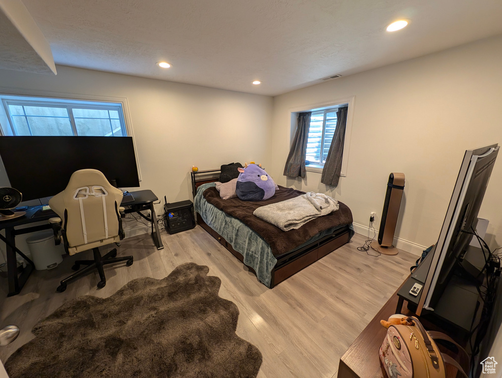 Bedroom with light hardwood / wood-style flooring